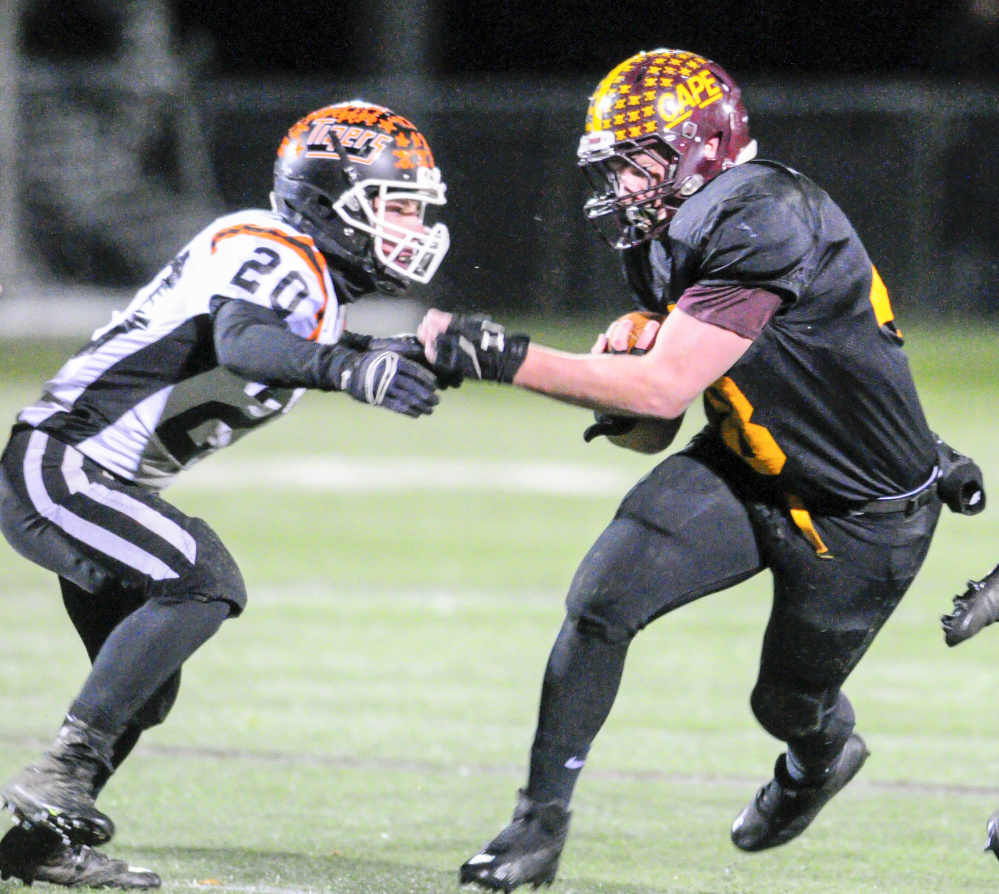 Gardiner defender Nate Malinowski, left, tries to tackle Cape Elizabeth running back Ryan Weare during the Class C South title game last Friday in Cape Elizabeth.