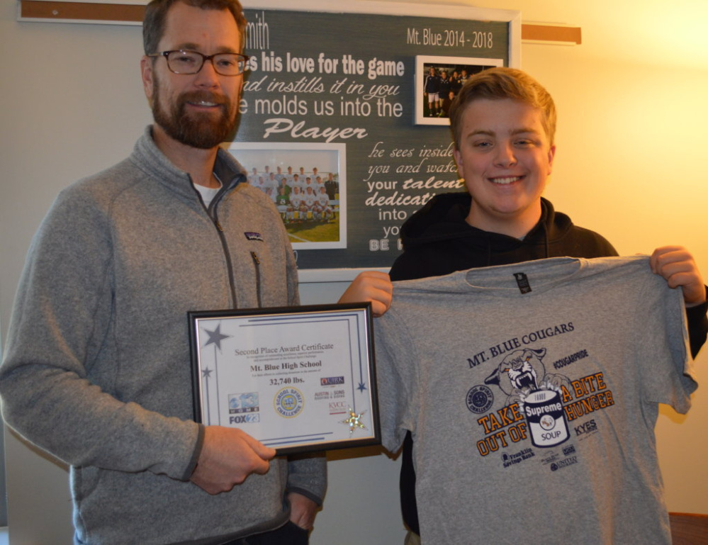 Mt. Blue High School students and staff collected the equivalent of 32,740 pounds of food to help people in need as part of WGME's School Spirit Challenge. The food was donated to the Good Shepherd Food Bank in Auburn, which distributes it to local food pantries around the state. Mt. Blue Assistant Principal Joel Smith, left, and Griffin Mayhew, president of the class of 2018 and school board representative, show off the certificate the school received for coming in second place and the T-shirts they had made to sell to help raise money.