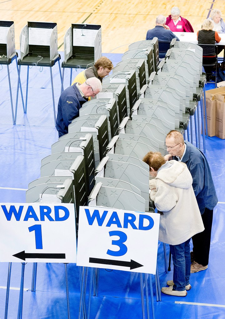 Lewiston residents cast their votes at the Lewiston Memorial Armory on Tuesday. On their local ballot was a proposal for Lewiston and Auburn to merge.