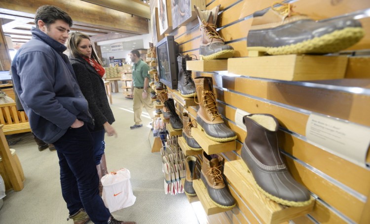 Patrons look at boots at the L.L. Bean store in Freeport. Sales of Bean boots have broken records.