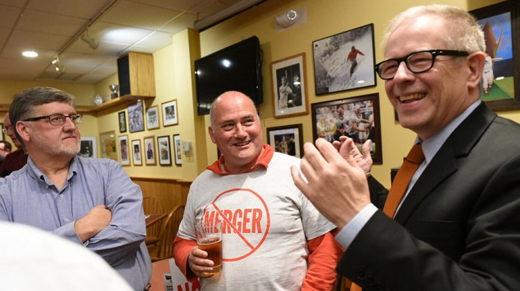 Members of the Coalition Opposed to Lewiston-Auburn Consolidation, from left, Robert Reed, Ron Potvin and Jim Howaniec, are all smiles after their anti-merger campaign was successful on Nov. 7. The group says it will continue on to help "raise the image" of the Lewiston-Auburn area.