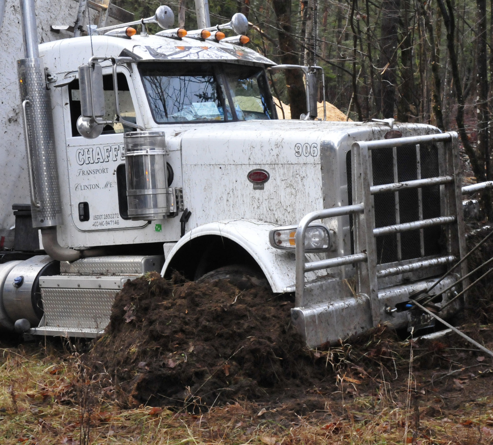 The front end of this tractor-trailer carrying sawdust dug into the ground after it overturned early Wednesday morning on Route 150 in Athens.