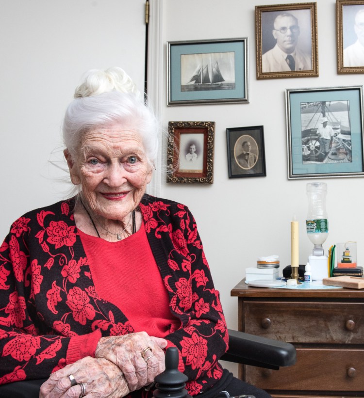 Hope Weston relaxes in her apartment Wednesday at Schooner Estates in Auburn. Behind her are photographs of her father when they lived in the Philippines before World War II, when the country was a U.S. possession.