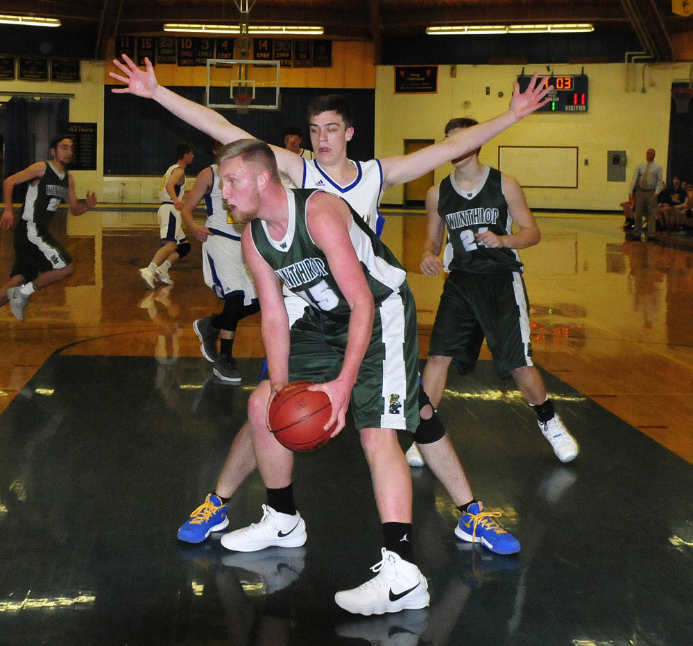 Winthrop's Cam Wood gets rebound while defended by Mt. Abram's Jack Deming during an MVC game Monday in Salem.