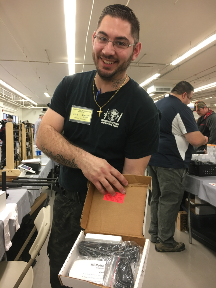 Ignazio "Iggy" Falcone, of Manchester, New Hampshire, displays a handgun in early 2017 at a gun show in Nashua, New Hampshire.