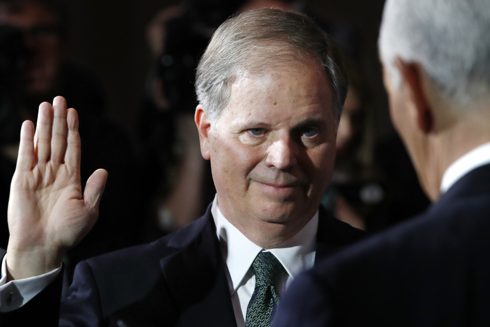 Sen. Doug Jones, D-Ala., listens as Vice President Mike Pence, right, administers the Senate oath of office during a mock swearing-in ceremony in the Old Senate Chamber on Capitol Hill in Washington.