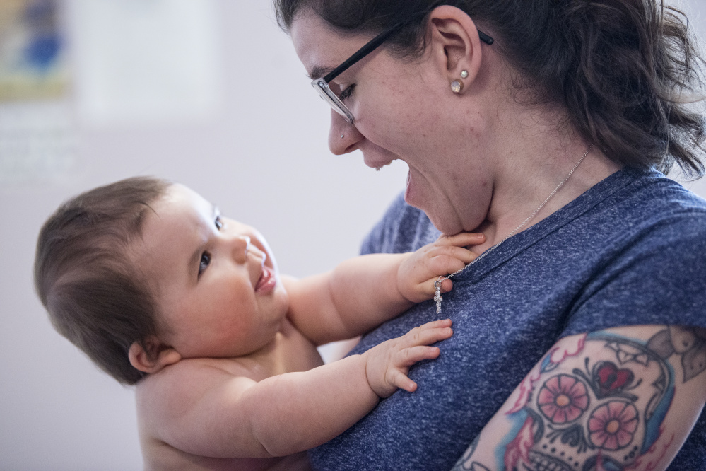 Kayla Clifton sits with her baby Lilly at the Mid-Maine Homeless Shelter on Wednesday. Karen Normandin, dean of students at Kennebec Valley Community College, is working with Clifton to pay off a back bill and get financial aid so she can return to her studies.