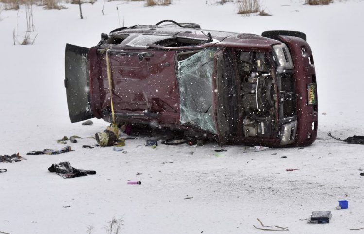 A burned, overturned truck lies on the ice of a small pond along Route 2 in Skowhegan early Monday. A pregnant woman died in the accident and the baby was reportedly delivered by C-section after the accident.