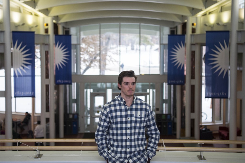 Michael Logan, a senior at Colby College, stands for a picture on the balcony overlooking the Joseph Family Spa at the Cotter Union at Colby College in Waterville on Tuesday. Logan has created a start-up company that offers restaurant deliveries to campus.