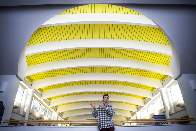 Michael Logan, a senior at Colby College stands for a picture on the balcony overlooking the Joseph Family Spa at the Cotter Union at Colby College in Waterville on Tuesday. Logan has created a start-up company that offers restaurant deliveries to campus.