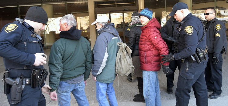 Augusta police arrest four protesters Monday at Central Maine Power Co.'s headquarters in Augusta. The four from the group Speak The Truth to CMP "volunteered" to be detained by police after refusing to disperse during a protest to raise awareness about CMP's opposition to net metering.