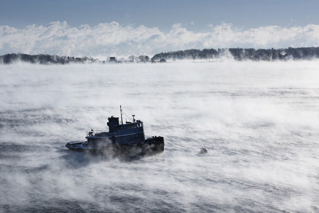 The tugboat Capt. Mackintire is moored off Portland's Eastern Promenade in frigid weather in December. The vessel sank early Thursday after a collision with another tugboat that was towing it. The Capt. Mackintire had no crew on board and no one was injured, the Coast Guard reported.