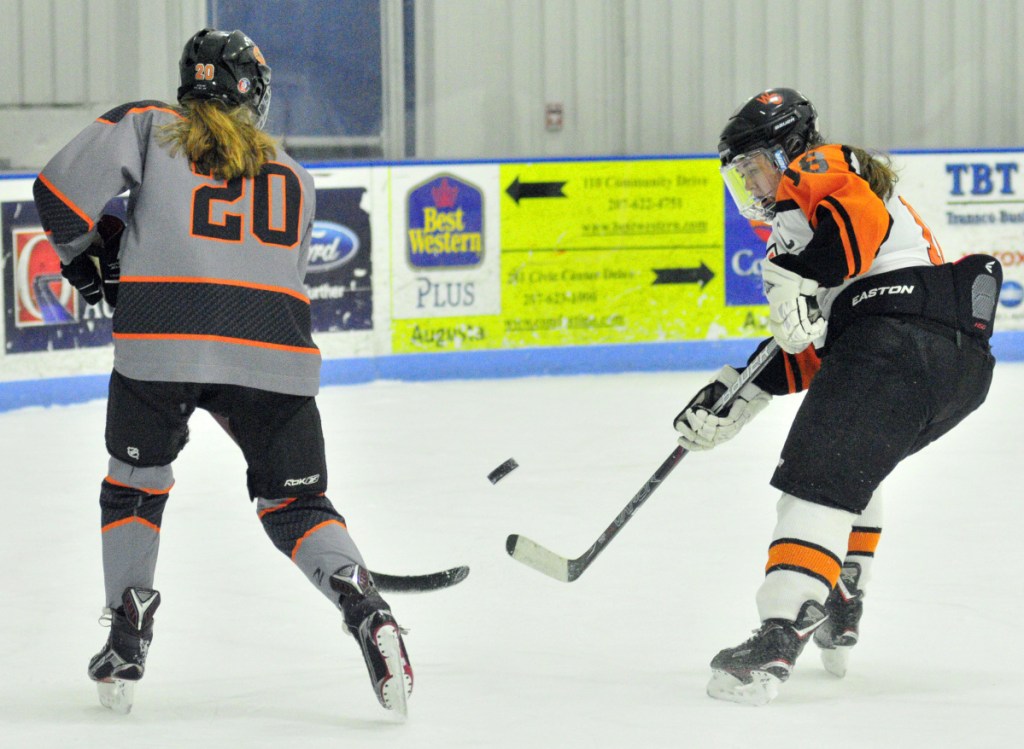 Brunswick's Harriet Peabody, left, and Winslow/Gardiner's Bailey Robbins compete for a puck during a North quarterfinal game Thursday at the Camden National Bank Ice Vault in Hallowell.