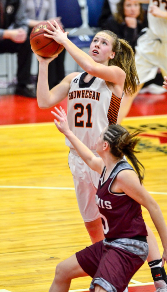 Skowhegan's Annie Cooke, top, shoots over Nokomis' Maya Cooney during a Class A North quarterfinal game Friday at the Augusta Civic Center.