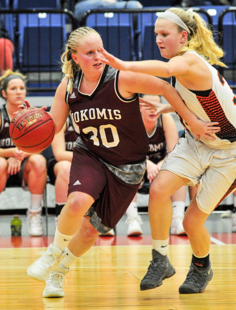 Nokomis' Hanna Meservey, left, drives around Skowhegan's Mariah Dunbar during a Class A North quarterfinal game Friday at the Augusta Civic Center.