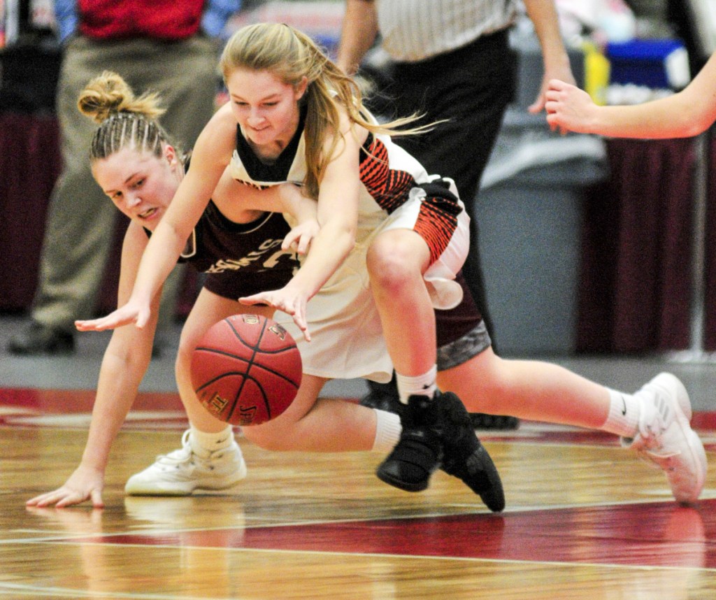 Nokomis' Maci Leali, left, and Skowhegan's Mariah Dunbar battle for a loose ball during a Class A North quarterfinal game Friday  at the Augusta Civic Center.