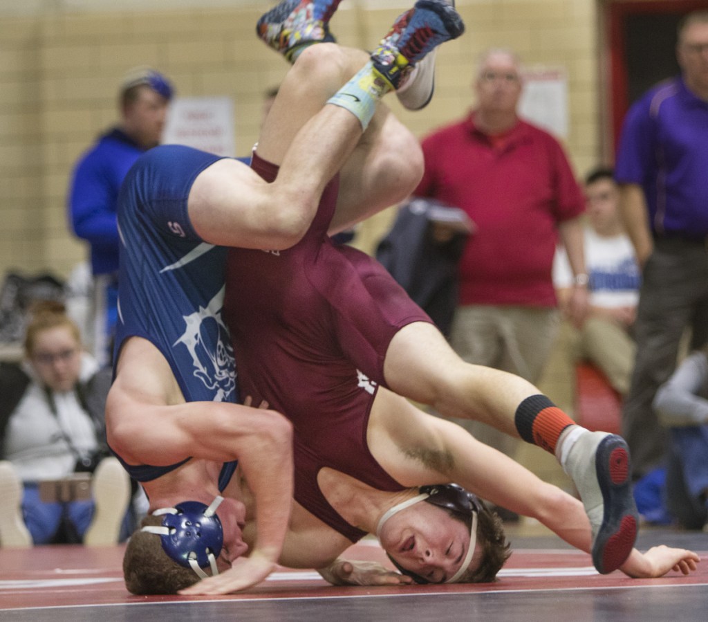 Portland Press Herald photo by Carl D. Walsh
Portland's Zackary Elowitch and Nokomis' Quinton Richards roll on their heads during the 152-pound match at the Class A wrestling championships Saturday in Sanford.