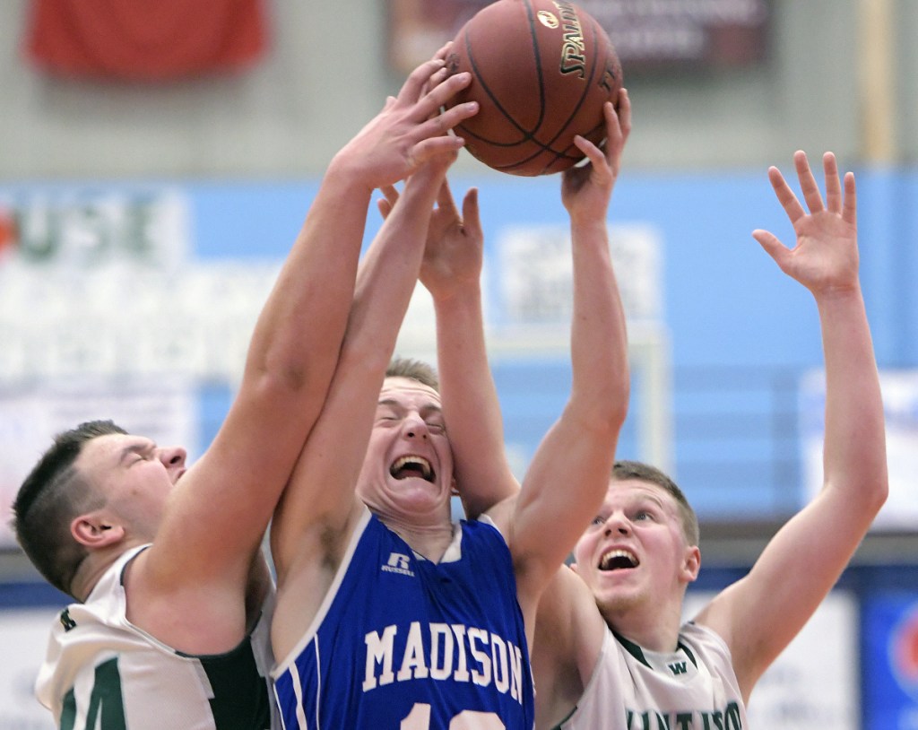 Winthrop's Sam Figueroa, left, and Nate Leblanc, right, block Madison's Evan Bess during a Class C South quarterfinal game Monday at the Augusta Civic Center.