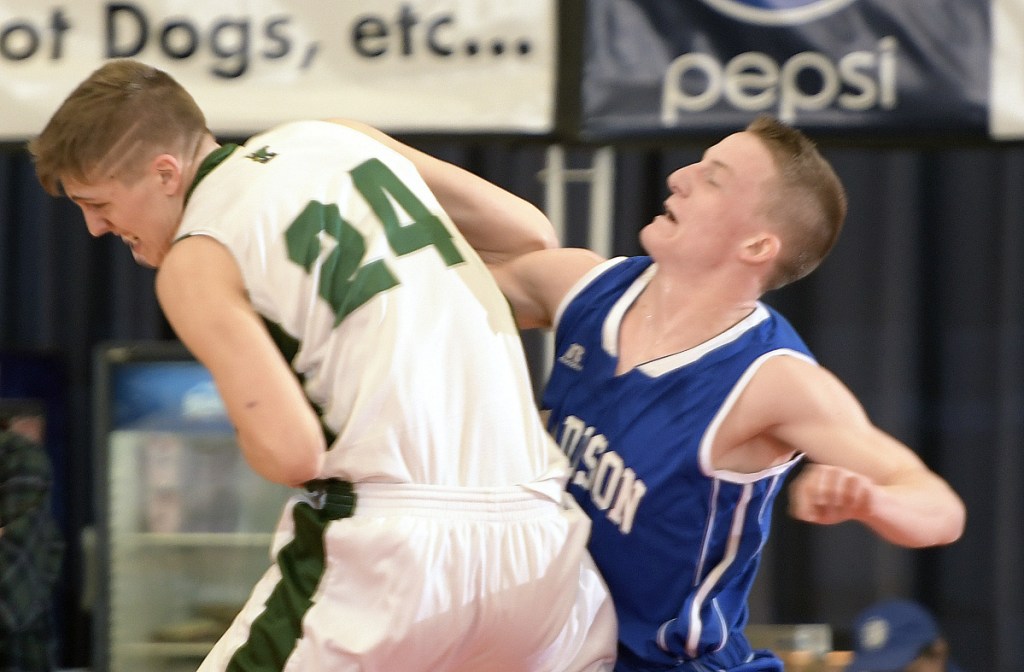 Winthrop's Jevin Smith rips a rebound from Madison's Evan Bess during a Class C South quarterfinal game Monday afternoon at the Augusta Civic Center.