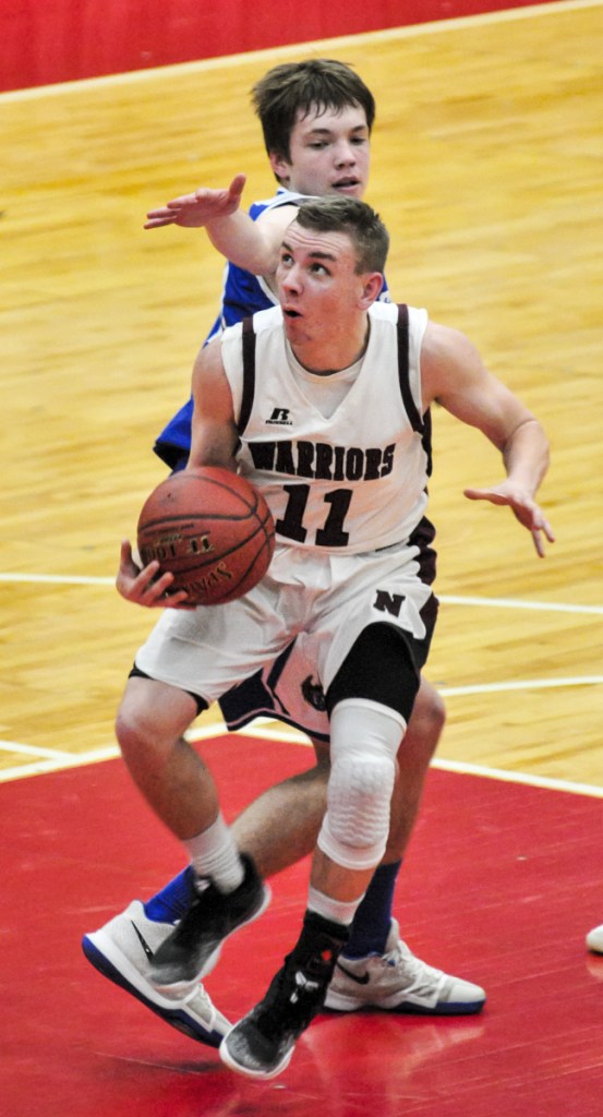 Nokomis' Andrew Haining, left, shoots as Erskine's Jacob Praul defends during a Class A North quarterfinal game Saturday at the Augusta Civic Center.