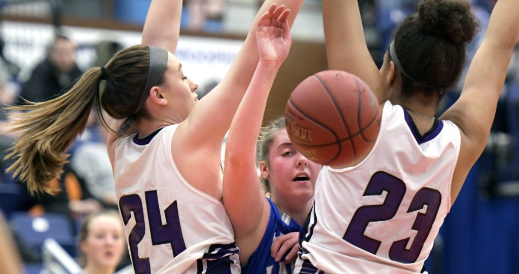 Hampden's Sophia Narofsky, left, and Bailey Donovan double team Lawrence'a Molly Folson during a Class A North semifinal game Wednesday at the Augusta Civic Center.