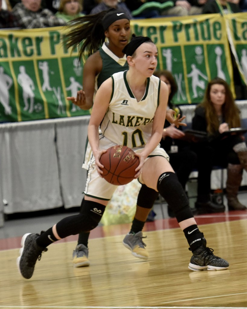 Rangeley junior Brooke Egan looks to pass as Temple's Selam Heinrich defends during a Class D South semifinal game Thursday at the Augusta Civic Center.