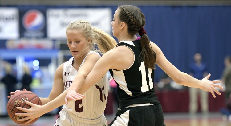 Monmouth's Audrey Fletcher dribbles around St. Dominic Academy's Rileigh Stebbins during a Class C South quarterfinal game Tuesday at the Augusta Civic Center.