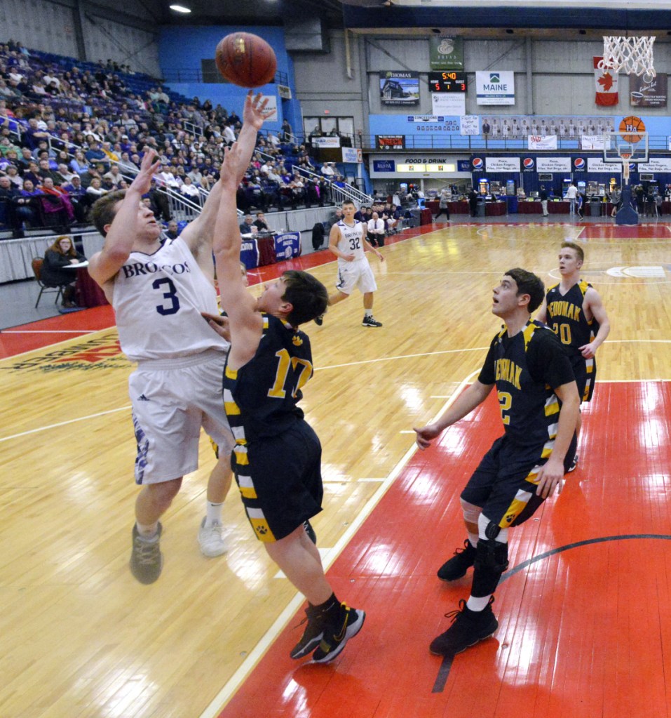 Hampden's Kory Winch, left, shoots over Medomak's Ryan Creamer during the Class A North championship game Friday night at the Augusta Civic Center.