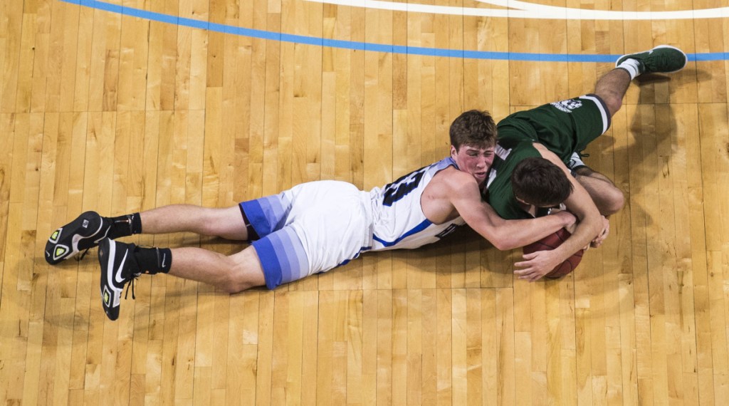 Hermon's Garrett Trask, left, and Mount Desert Island's James McConomy try to get control of a loose ball during the Class B North championship game Saturday at the Cross Insurance Center in Bangor.