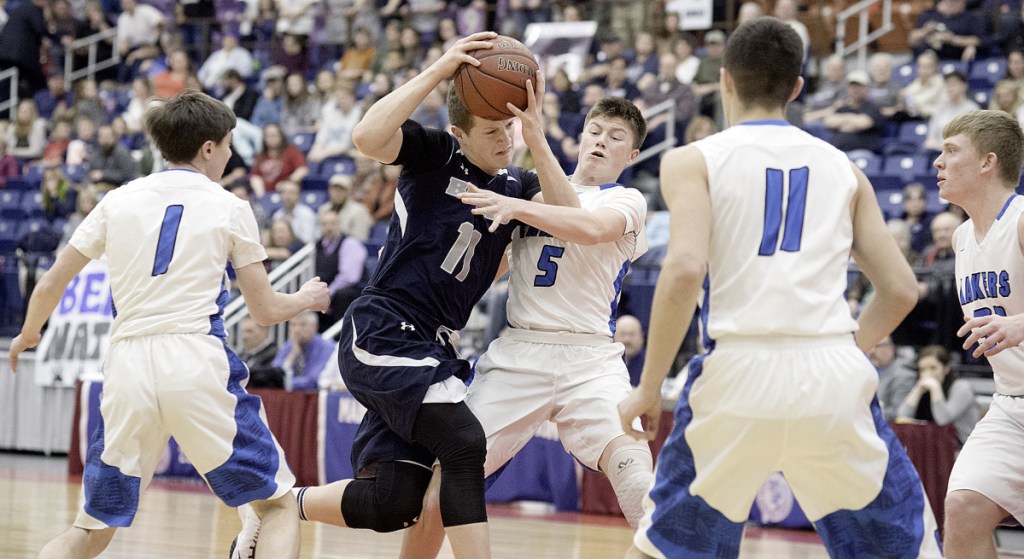 Ernie Lorange of Gould drives through traffic during the Class D South final against top seed Greenville at the Augusta Civic Center on Saturday afternoon.