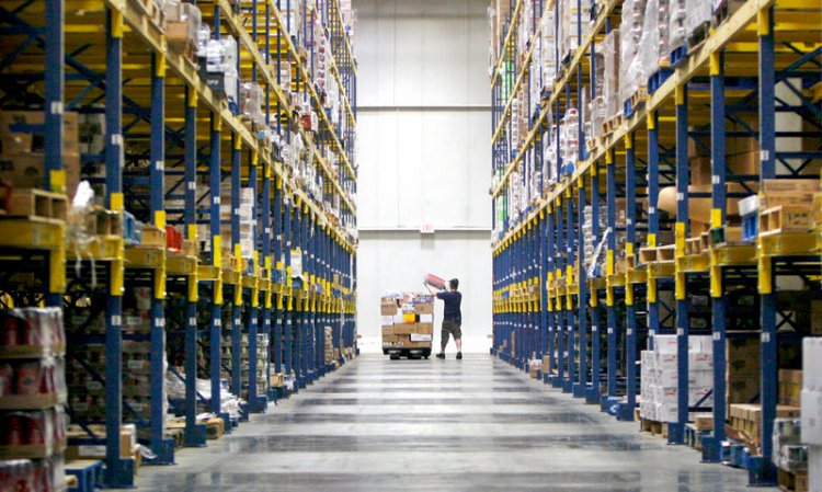 A Hannaford employee loads a jack with products in one of the numerous aisles in the warehouse at the distribution center in South Portland in 2014.