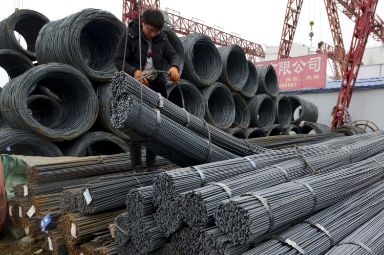 A worker loads steel products onto a vehicle at a steel market in Fuyang in central China's Anhui province Friday, March 2, 2018. China has expressed "grave concern" about a U.S. trade policy report that pledges to pressure Beijing but had no immediate response to President Donald Trump's plan to hike tariffs on steel and aluminum. The Commerce Ministry said Friday that Beijing has satisfied its trade obligations and appealed to Washington to settle disputes through negotiation (Chinatopix Via AP)