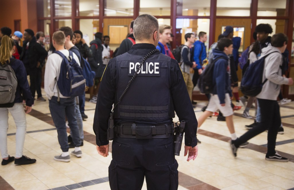 South Portland High School resource officer Alfred Giusto stands outside the main office as students exit for the weekend.