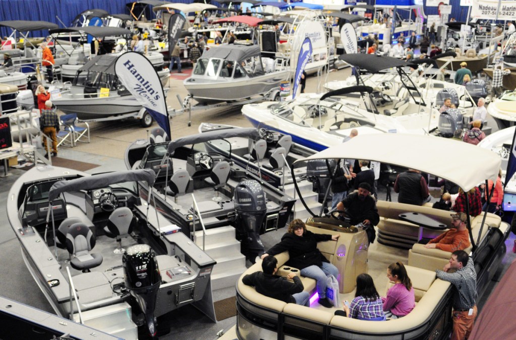 People look over the boats on display Saturday during the Augusta Boat Show in the Paul G. Poulin Auditorium of the Augusta Civic Center.