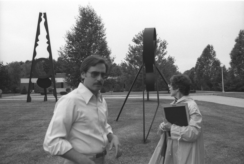 Curator Robert Katz and T.W. Dick Steel Co. CEO Myrtle Willey tour a Sasson Soffer exhibit in 1983 at the University of Maine at Augusta.