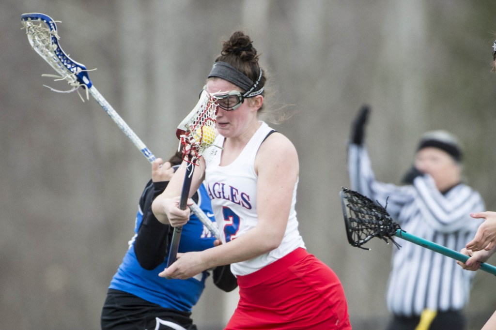 Messalonskee's Kaitlyn Smith (2) drives to the net as she is defended by Mt. Ararat's Maddie Horrocks (25) on Friday at Thomas College in Waterville.