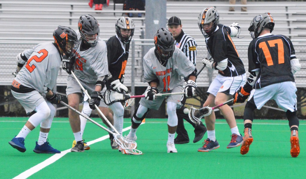 Gardiner's Matt Boynton (14), Jake Weston (17) and Shawn Michaud (11) battle with Brunswick's Connor Foye (2), Jared Hummer (19) and Kiko Lopez (11) for a loose ball Tuesday at Bowdoin College in Brunswick.