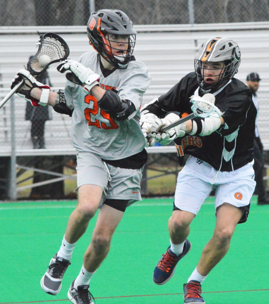 Brunswick's Jacob Belanger (25) looks to get past the defense of Gardiner's Shawn Michaud on Tuesday at Bowdoin College in Brunswick.