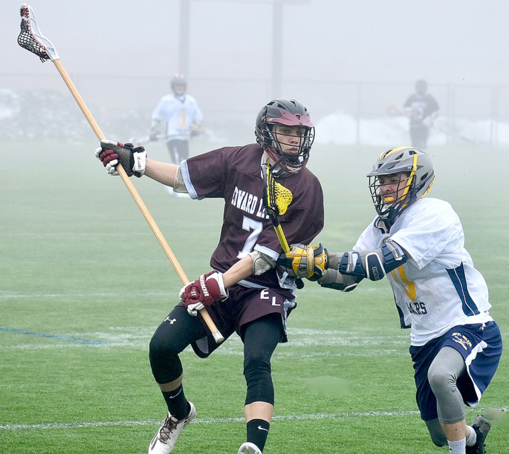 Edward Little's Storm Jipson (7) tries to ward off Mt. Blue's Justin Theriault during a KVAC game Tuesday at Kents Hill School.