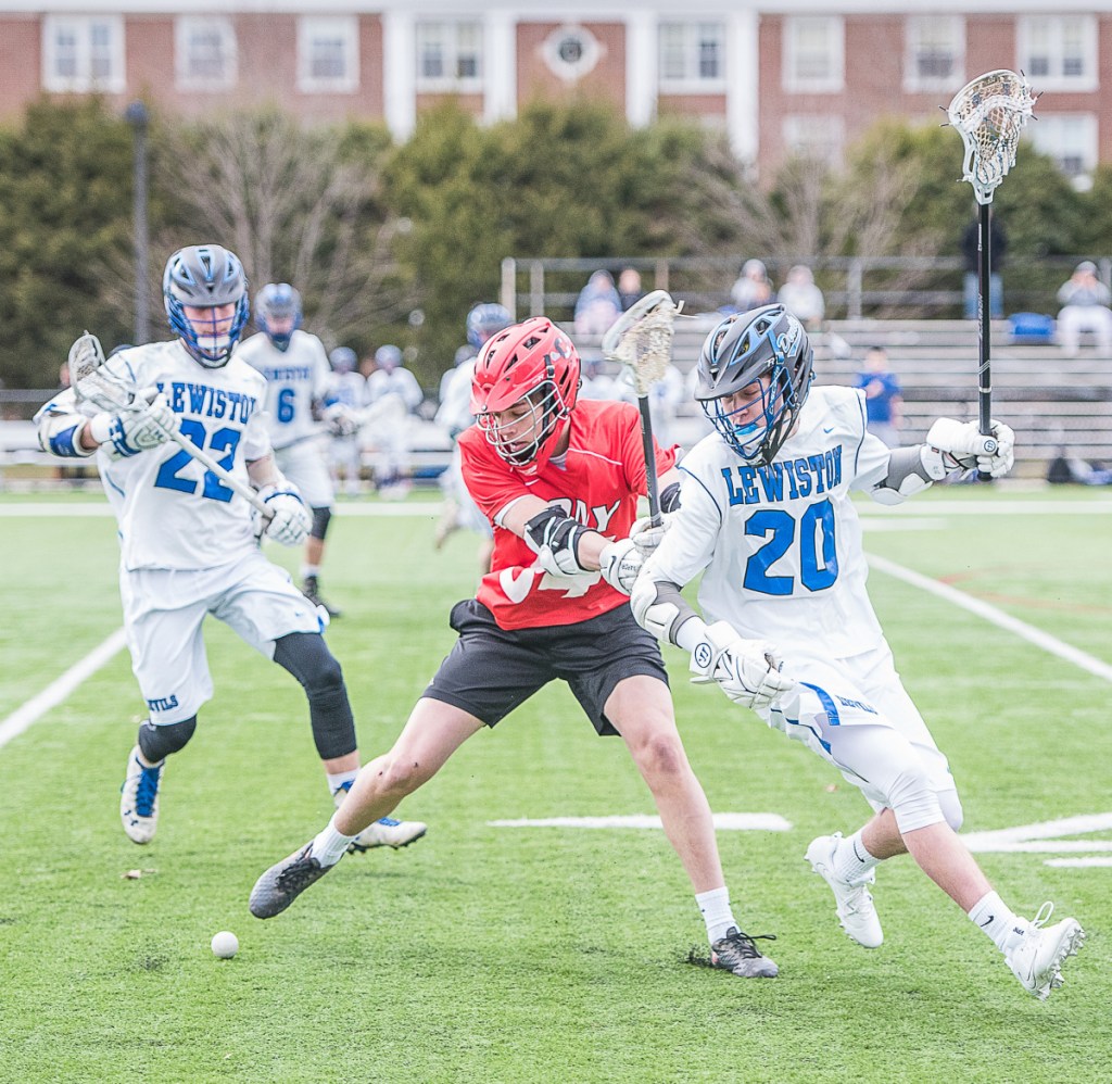 Cony's Ian Bowers and Lewiston's Tyler Marcoux double back for a loose ball during Wednesday's lacrosse game at Garcelon Field at Bates College in Lewiston.