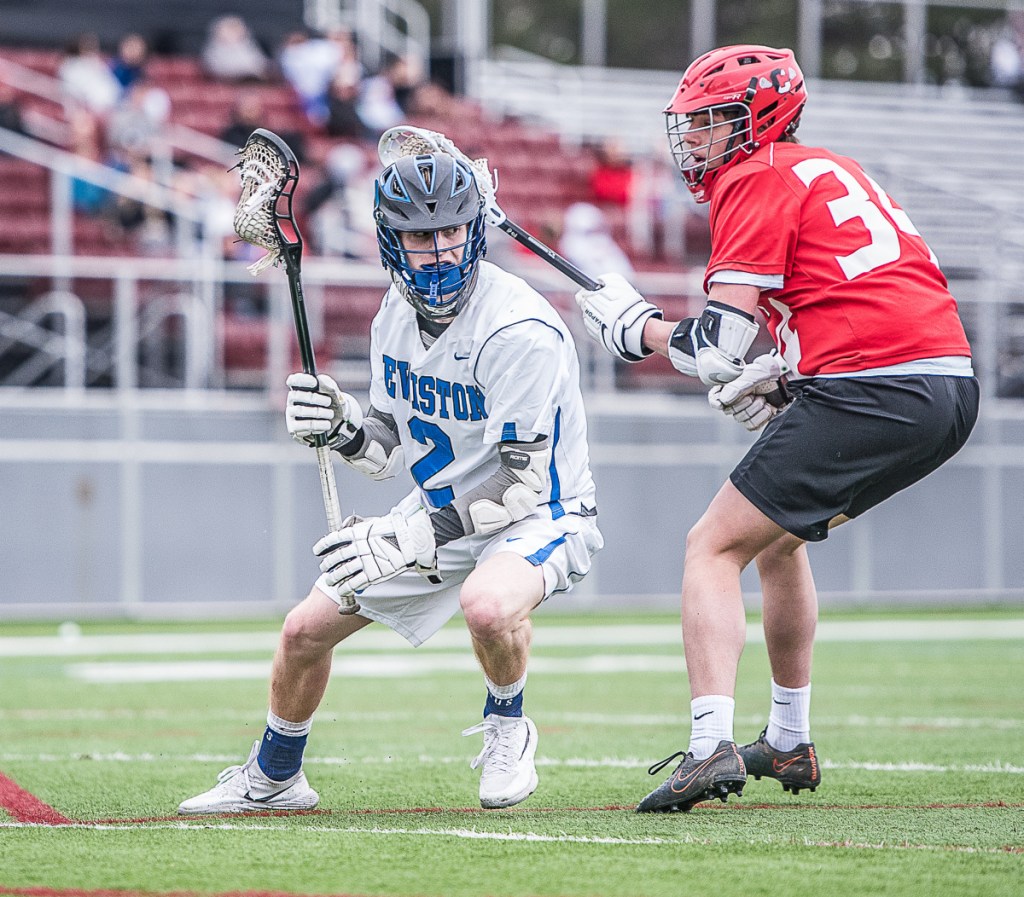 Sun Journal photo by Andree Kehnn
Lewiston's Jayden Wilson controls the balls while Cony'sIan Bowers gives chase during Wednesday's lacrosse game in Lewiston.