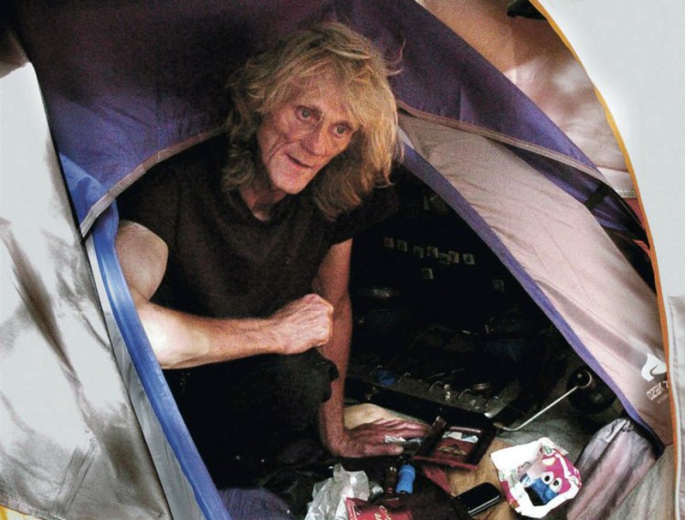 Homeless person Vaughan Orchard speaks from inside his tent near the Kennebec River in Waterville on Sept. 7, 2016. 