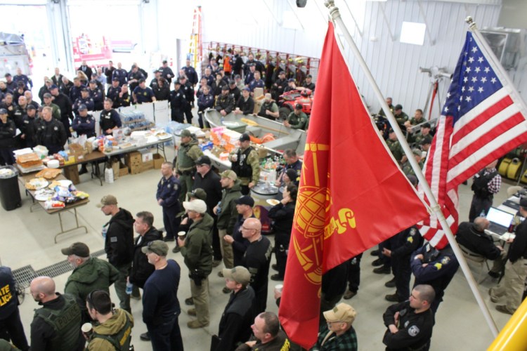 Some of the 200 officers from county, state, municipal and federal agencies are seen Thursday in an incident command center in Norridgewock as they receive a briefing and their assignments in the manhunt for police-killer suspect John Williams.