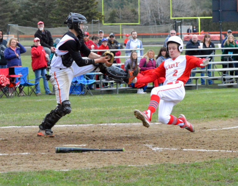 Times Record photo by Eric Maxim 
 Brunswick catcher Scout Masse jumps for the ball before tagging out Bobby Stolt (2) at the plate in the fourth inning Saturday in Brunswick.