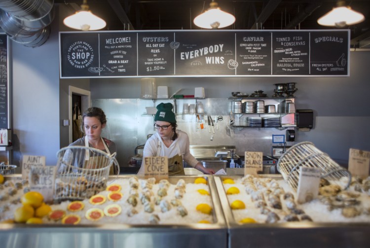 Leslie Murray, left, and Jen Wyllie work at the raw bar.