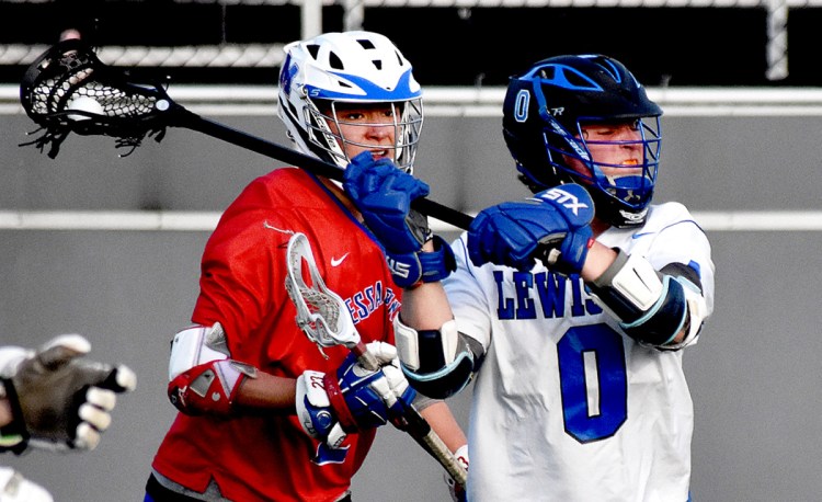 Lewiston High School's Sam Payne (0) winds up for a shot in front of Messalonskee's Dan Gusmanov during their game on Garcelon Field at Bates College in Lewiston on Tuesday.