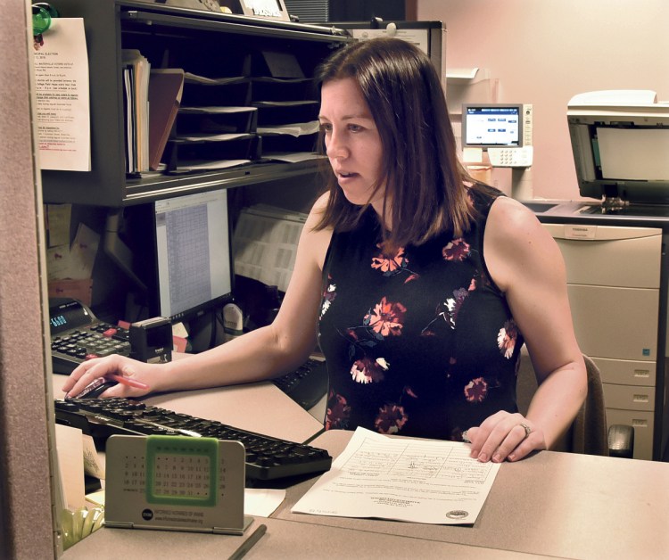 Waterville Deputy Clerk Sarah Cross verifies signatures of residents that were handed in before the deadline for the petition to recall Mayor Nick Isgro on Wednesday. Cross said the clerk's office was busy with more than 200 signatures dropped off that will need to be verified in the next 10 days.