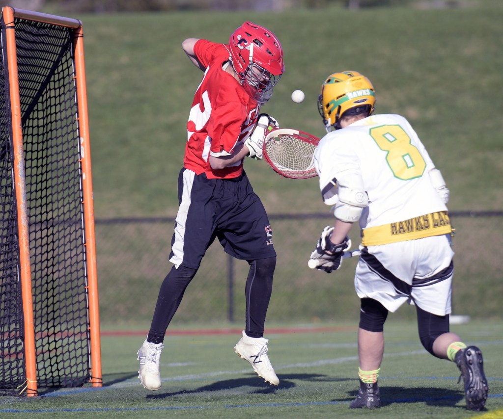 Maranacook/Winthrop's Collin Osbourne (8) chases a shot toward the net held by Cony's Cam Gallant on Tuesday in Readfield.