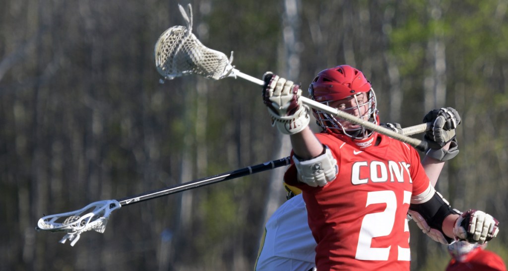 Maranacook/Winthrop's Ben Douin, back, collides with Cony's Nick Robinson, who holds onto the ball, Tuesday in Kents Hill.