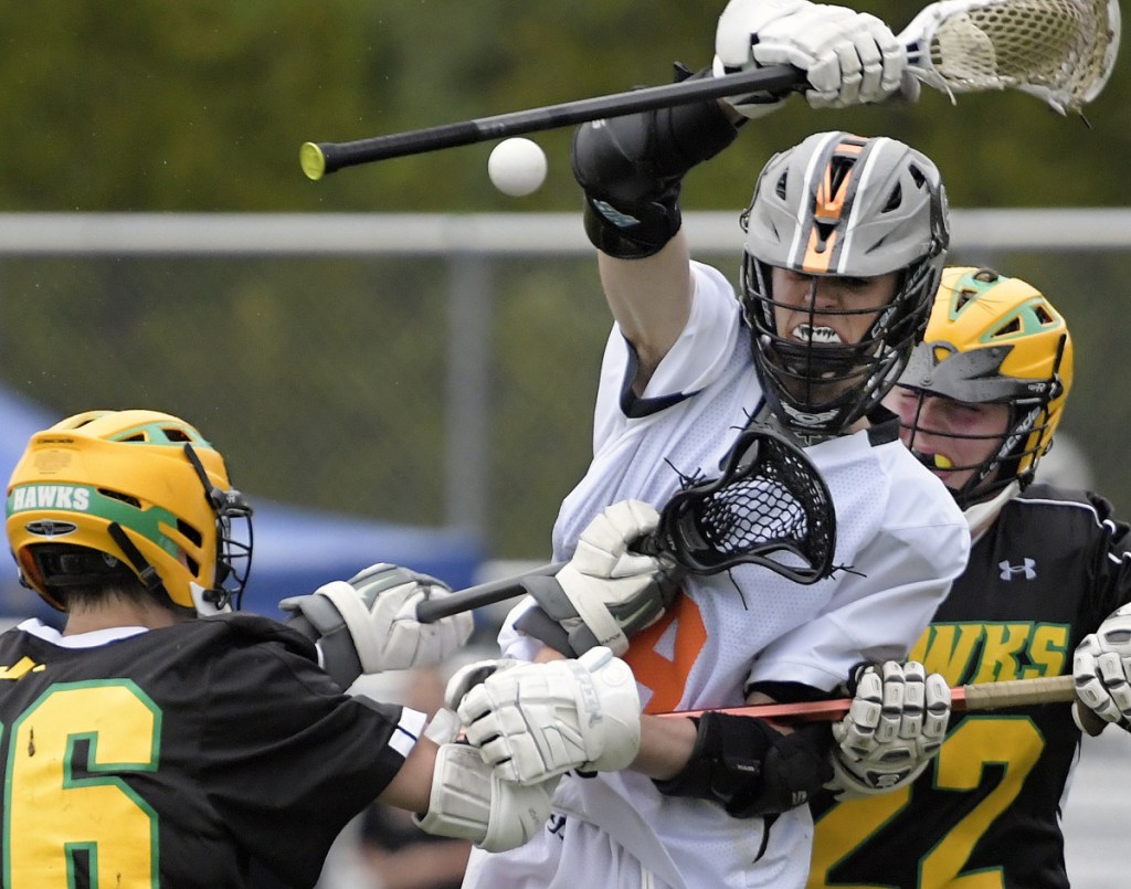 Gardiner's Marshall Clements, center, loses the ball while barricaded by Maranacook/Winthrop's Owen Austin, left, and Gavin Towns on Tuesday in Gardiner.